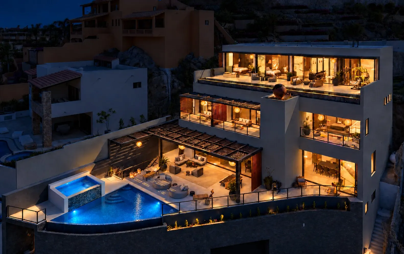 Lucia Noir Mansion lit up at night in Cabo San Lucas